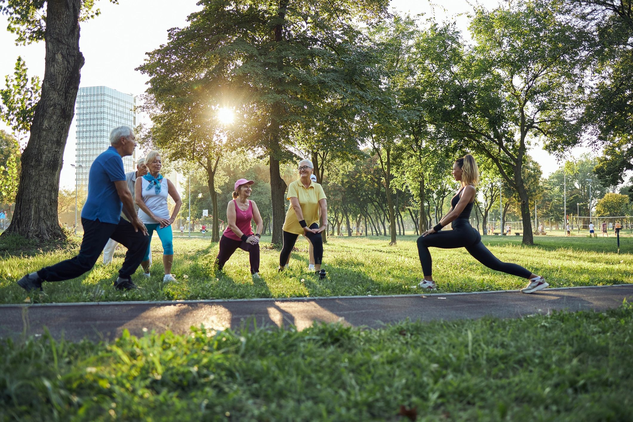 Active adults exercising together outdoors with a coach