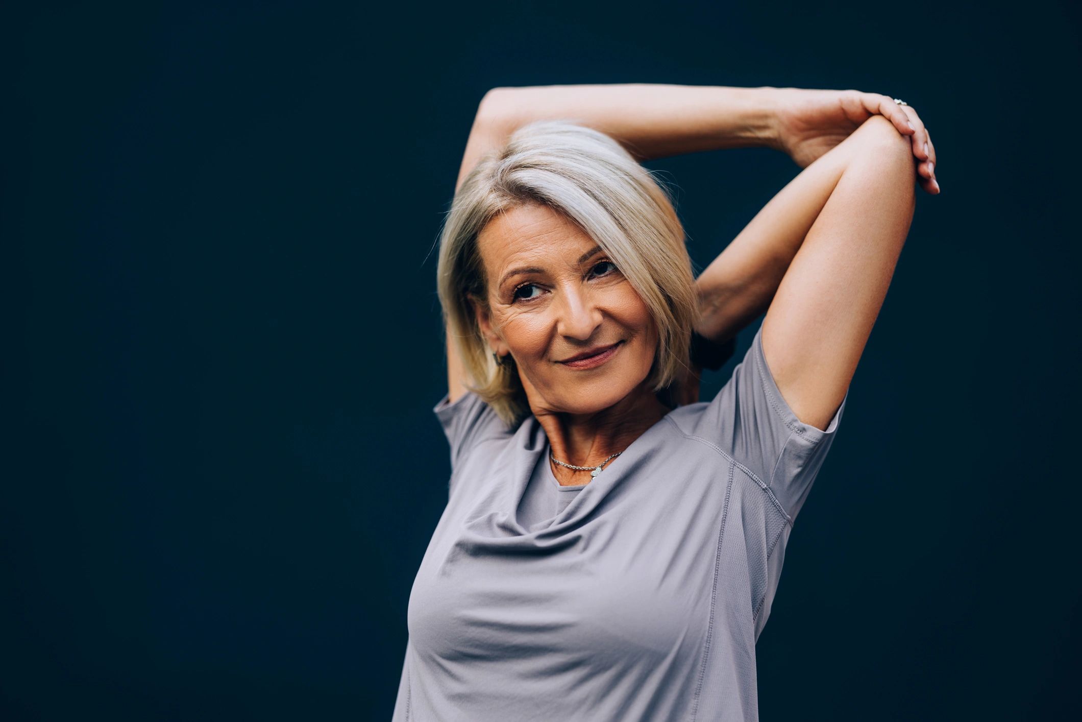 Mature woman warming up before strength training