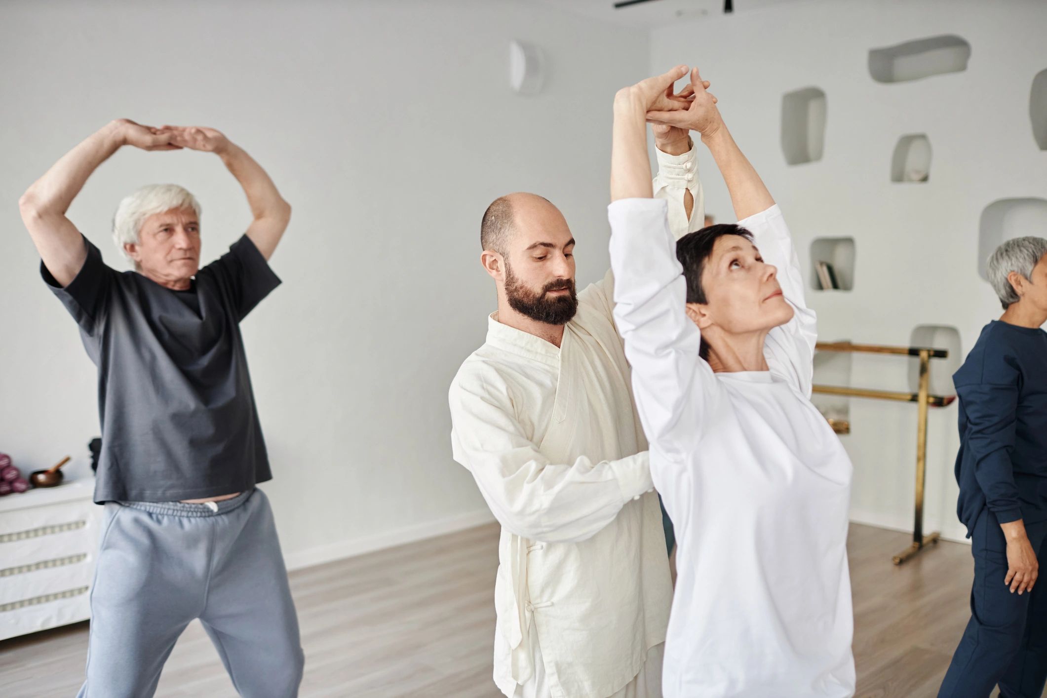 Trainer guiding older adults through a fitness session